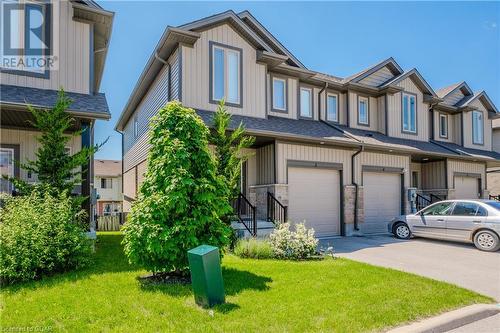 View of front of house with a garage and a front lawn - 1023 Devonshire Avenue Unit# 3, Woodstock, ON - Outdoor With Facade