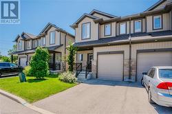 View of property featuring a garage and a front lawn - 