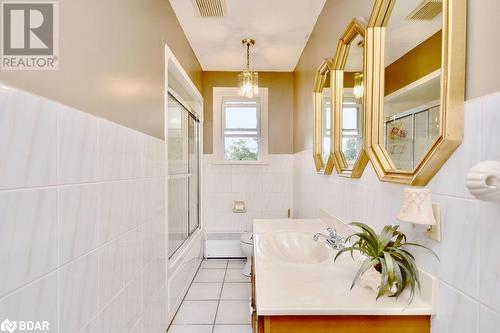 Full bathroom with toilet, tile walls, tile patterned flooring, bath / shower combo with glass door, and vanity - 264 Salem Road, Barrie, ON 