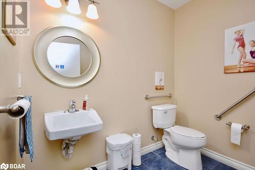 Bathroom featuring toilet, sink, and tile patterned flooring - 264 Salem Road, Barrie, ON 