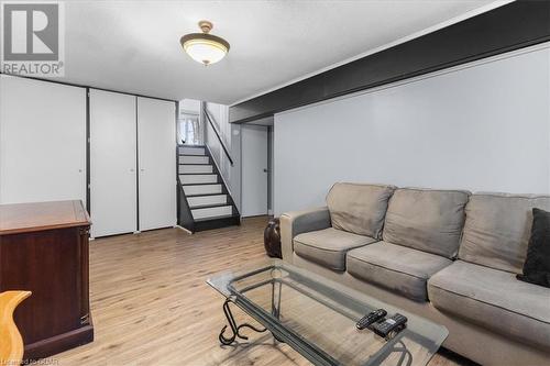 Living room with a textured ceiling and light wood-type flooring - 253 Auden Road, Guelph, ON - Indoor Photo Showing Living Room