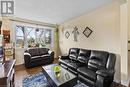 Tiled living room with baseboard heating and a textured ceiling - 253 Auden Road, Guelph, ON  - Indoor Photo Showing Living Room 