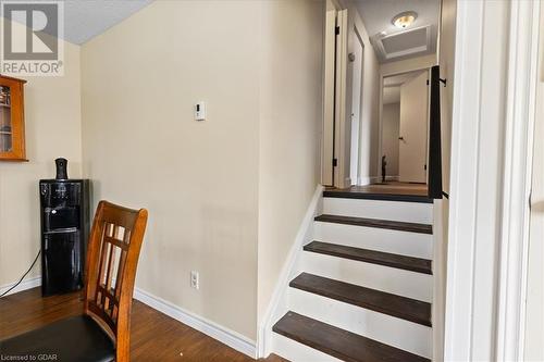 Staircase featuring hardwood / wood-style floors and a textured ceiling - 253 Auden Road, Guelph, ON - Indoor Photo Showing Other Room