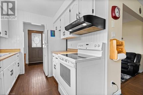 Kitchen featuring white cabinets, dark hardwood / wood-style floors, and white electric stove - 253 Auden Road, Guelph, ON - Indoor Photo Showing Kitchen