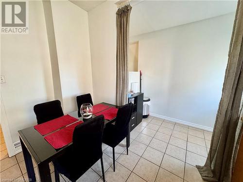 Dining space featuring light tile patterned floors - 21 Minto Avenue, Hamilton, ON 