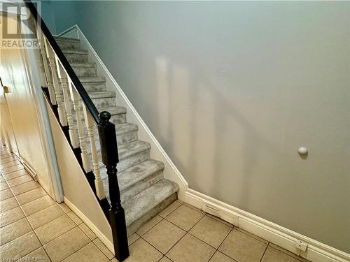 Stairs with tile patterned floors - 21 Minto Avenue, Hamilton, ON 