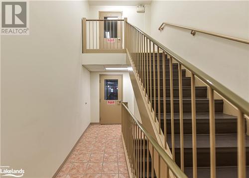 Staircase featuring tile patterned flooring - 107 Bond Street Unit# 201, Orillia, ON - Indoor Photo Showing Other Room