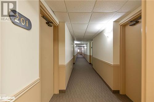 Corridor with a drop ceiling and carpet flooring - 107 Bond Street Unit# 201, Orillia, ON - Indoor Photo Showing Other Room