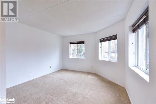 View of carpeted empty room - 107 Bond Street Unit# 201, Orillia, ON - Indoor Photo Showing Other Room