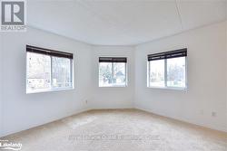 Carpeted empty room featuring a textured ceiling and a healthy amount of sunlight - 