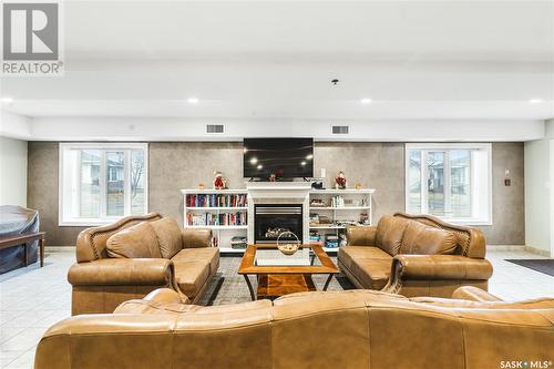 404 2909 Arens Road E, Regina, SK - Indoor Photo Showing Living Room With Fireplace