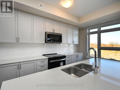 121 - 1573 Rose Way, Milton, ON - Indoor Photo Showing Kitchen With Double Sink