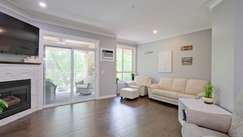 104-1966 Enterprise Way, Kelowna, BC - Indoor Photo Showing Living Room With Fireplace