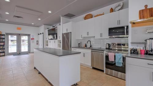 104-1966 Enterprise Way, Kelowna, BC - Indoor Photo Showing Kitchen With Stainless Steel Kitchen