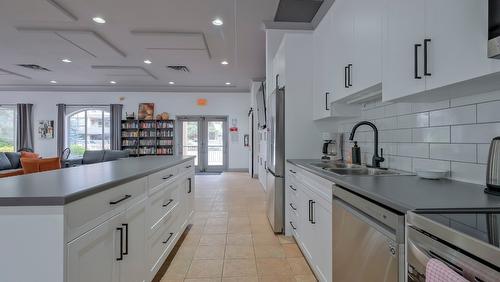 104-1966 Enterprise Way, Kelowna, BC - Indoor Photo Showing Kitchen With Stainless Steel Kitchen With Upgraded Kitchen