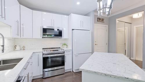 104-1966 Enterprise Way, Kelowna, BC - Indoor Photo Showing Kitchen With Double Sink