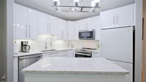 104-1966 Enterprise Way, Kelowna, BC - Indoor Photo Showing Kitchen With Stainless Steel Kitchen With Double Sink With Upgraded Kitchen