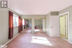 Unfurnished bedroom with light carpet and two closets - 