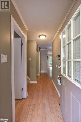 Hallway with a textured ceiling, light hardwood / wood-style flooring, and crown molding - 441 Barrie Road Unit# 34, Orillia, ON - Indoor Photo Showing Other Room