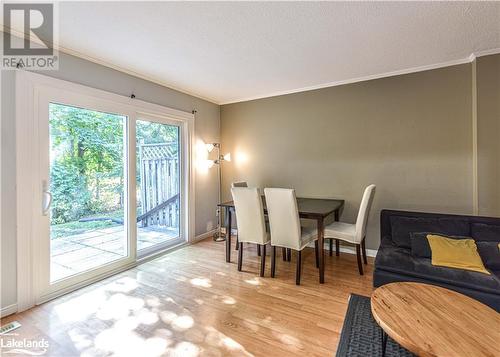 Dining space featuring a textured ceiling, ornamental molding, and light hardwood / wood-style flooring - 441 Barrie Road Unit# 34, Orillia, ON - Indoor