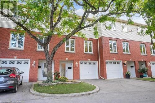 View of property featuring a garage - 130 Livingston Avenue Unit# 21, Grimsby, ON - Outdoor With Facade