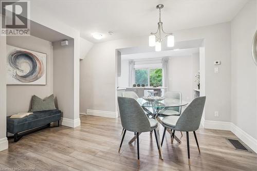 Dining space with a notable chandelier and light hardwood / wood-style flooring - 130 Livingston Avenue Unit# 21, Grimsby, ON - Indoor Photo Showing Dining Room