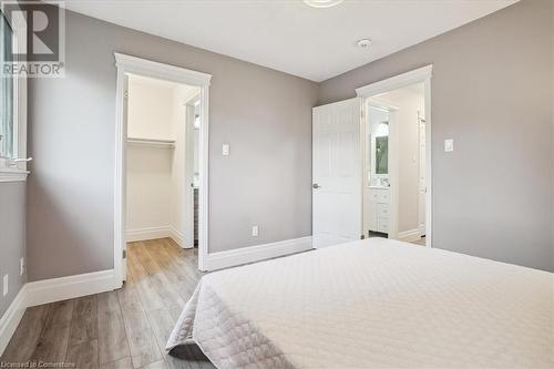 Bedroom with a closet, a walk in closet, and light hardwood / wood-style flooring - 130 Livingston Avenue Unit# 21, Grimsby, ON - Indoor