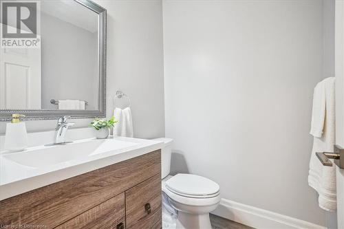 Bathroom with hardwood / wood-style floors, vanity, and toilet - 130 Livingston Avenue Unit# 21, Grimsby, ON - Indoor Photo Showing Bathroom