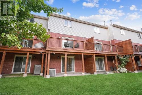 Rear view of property with cooling unit and a yard - 130 Livingston Avenue Unit# 21, Grimsby, ON - Outdoor With Deck Patio Veranda