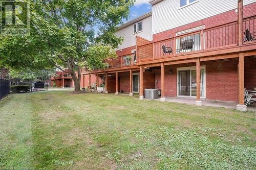 View of yard with central AC unit and a wooden deck - 130 Livingston Avenue Unit# 21, Grimsby, ON - Outdoor With Deck Patio Veranda