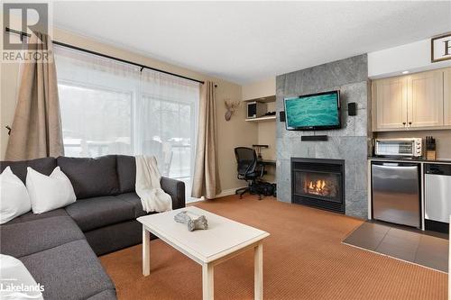 1235 Deerhurst Drive Unit# 52-107, Huntsville, ON - Indoor Photo Showing Living Room With Fireplace