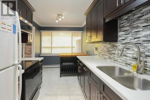 336 - 3055 Tomken Road, Mississauga, ON - Indoor Photo Showing Kitchen With Double Sink