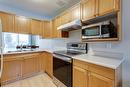 115-133 Wyndham Crescent, Kelowna, BC  - Indoor Photo Showing Kitchen With Double Sink 