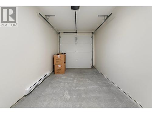 Single car secure parking garage - 727 Wardlaw Avenue Unit# 4, Kelowna, BC - Indoor Photo Showing Garage