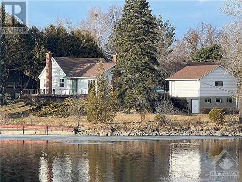 View from across the river - 5328 Kilby Lane, Manotick, ON - Outdoor With Body Of Water