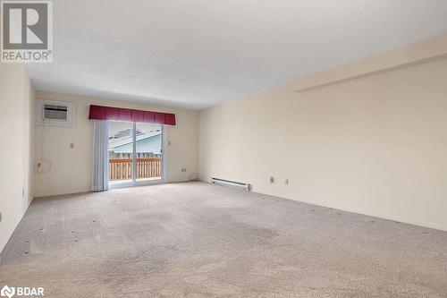 Spare room with light colored carpet, a wall mounted air conditioner, and a baseboard heating unit - 73 Lywood Street Unit# 2, Belleville, ON - Indoor Photo Showing Other Room