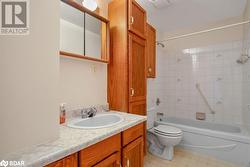 Full bathroom with vanity, toilet, and tiled shower / bath combo - 