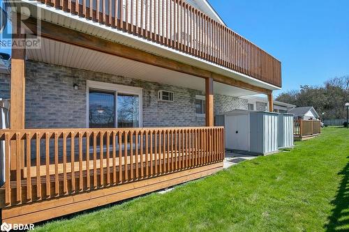 Back of house with a storage shed, a wooden deck, and a lawn - 73 Lywood Street Unit# 2, Belleville, ON - Outdoor With Deck Patio Veranda