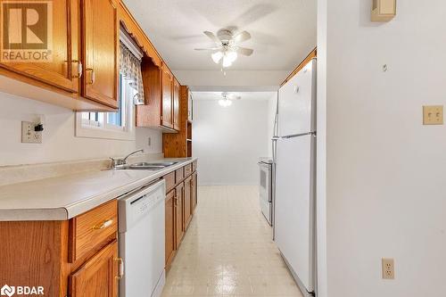 Kitchen with white appliances, sink, and ceiling fan - 73 Lywood Street Unit# 2, Belleville, ON - Indoor Photo Showing Kitchen With Double Sink