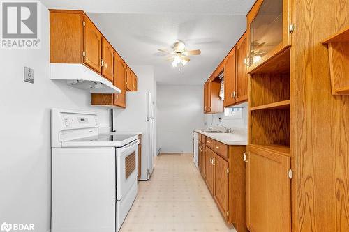 Kitchen featuring ceiling fan, a textured ceiling, sink, and white range - 73 Lywood Street Unit# 2, Belleville, ON - Indoor