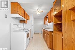 Kitchen featuring ceiling fan, a textured ceiling, sink, and white range - 