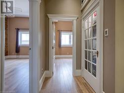 Hallway with a wealth of natural light and light hardwood / wood-style flooring - 