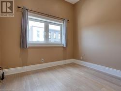 Spare room featuring light hardwood / wood-style flooring and french doors - 