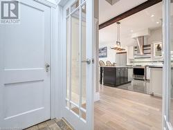 Bathroom with beamed ceiling, wood-type flooring, and backsplash - 