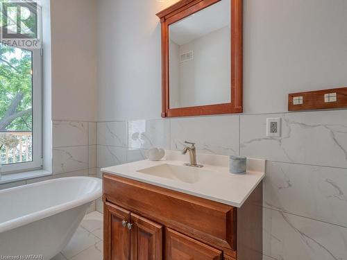 Bathroom with vanity, a washtub, and tile walls - 151 Thames Street S, Ingersoll, ON 