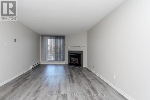 209 - 440 Wellington Street, St. Thomas, ON - Indoor Photo Showing Living Room With Fireplace