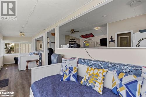 Bedroom with dark wood-type flooring and white fridge - 68 Wolverine Beach Rd, Port Severn, ON - Other