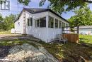 View of home's exterior with a sunroom and a yard - 68 Wolverine Beach Rd, Port Severn, ON  - Outdoor 