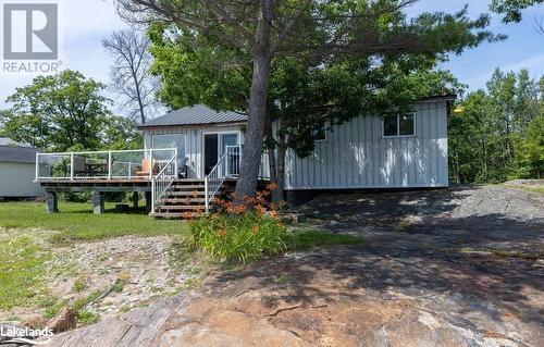 View of front of property featuring a deck - 64 Wolverine Beach Road, Port Severn, ON - Outdoor With Deck Patio Veranda