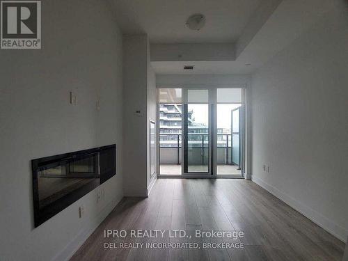 403 - 20 Shore Breeze Drive, Toronto, ON - Indoor Photo Showing Living Room With Fireplace